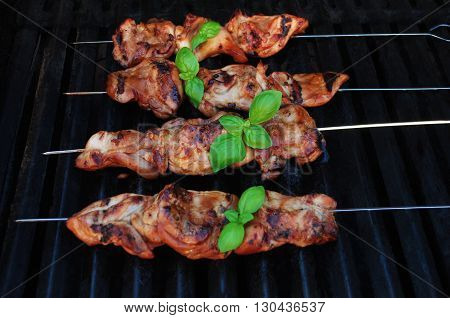 Chicken Teriyaki Kabobs Cooking on a Summer Grill with Fresh Basil