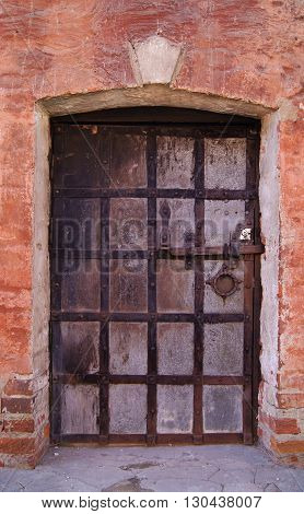 Ancient metal door in the brick restored castle