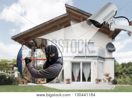 Surveillance Camera Capturing Burglar Using Crowbar To Open Glass Door