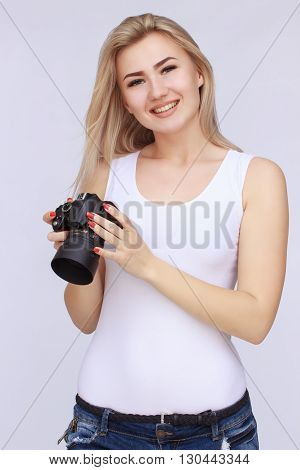 Happy smiling woman holding dslr camera on isolated background