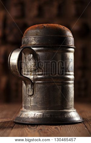 vintage sifter with cocoa powder on wooden table