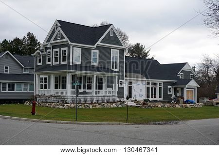 HARBOR SPRINGS, MICHIGAN / UNITED STATES - DECEMBER 24, 2015: A new home under construction at the corner of Fourth and Harrison Streets in Harbor Springs.