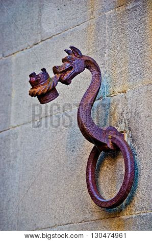 antique metal dragon is a bearer of a historic building