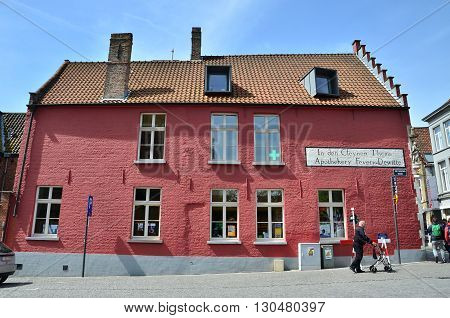 Bruges Belgium - May 11 2015: Tourists walking on street in Bruges Belgium. Bruges is the capital and largest city of the province of West Flanders in the Flemish Region of Belgium.