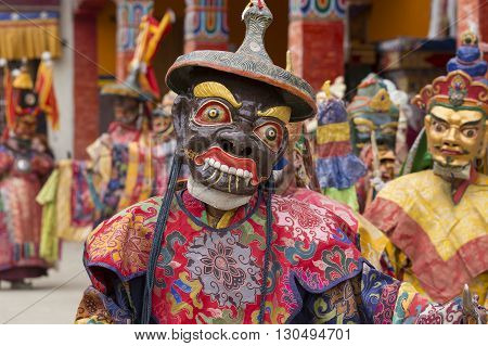 LAMAYURU INDIA - JUNE 13 2015: An unidentified buddhist lamas dressed in mystical mask dancing Tsam mystery dance in time of Yuru Kabgyat Buddhist festival at Lamayuru Gompa Ladakh North India