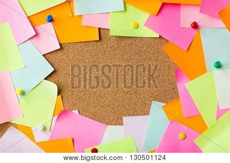 business, information, memo, management and education concept - close up of blank paper stickers on cork board
