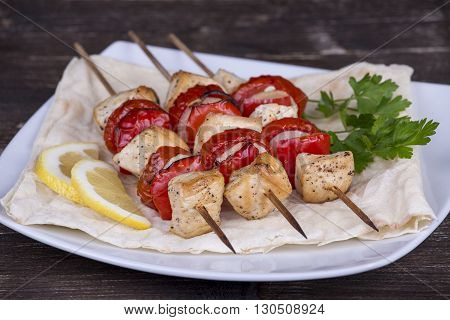 Grill chicken steak shish kabobs with vegetables in skewer on the plate