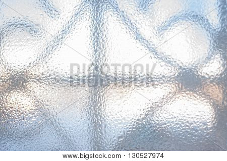 The grille shines across the glass is covered with  frozen and then slightly thawed water
