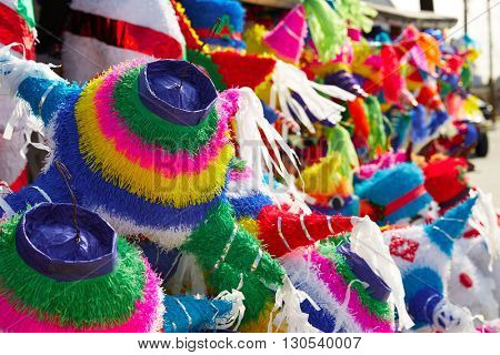 Mexican party pinatas decorated with fringed tissue colorful paper