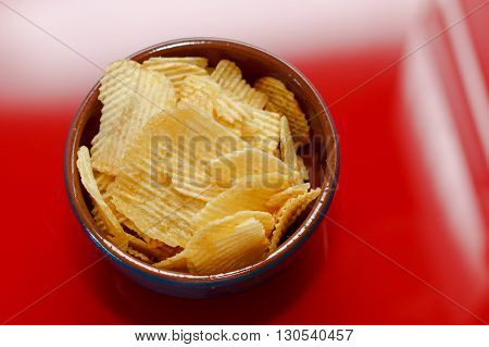 Rippled potato chips in a bowl closeup