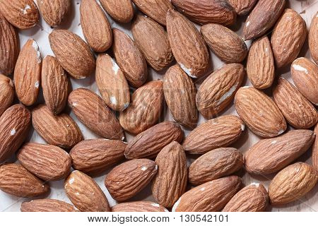 Many almonds without shell closeup background  macro