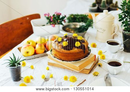 Traditional homemade chocolate cake. Rustic style and natural light. Chocolate Mud Cake on White table. Piece of chocolate cake with icing. Vanilla Cake with Chocolate Glaze.