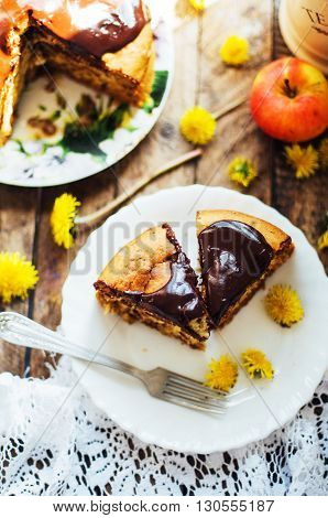 Traditional homemade chocolate cake. Rustic style and natural light. Chocolate Mud Cake on White table. Piece of chocolate cake with icing. Vanilla Cake with Chocolate Glaze.