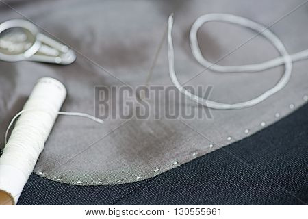 detail of sewing kit on the gray clothing