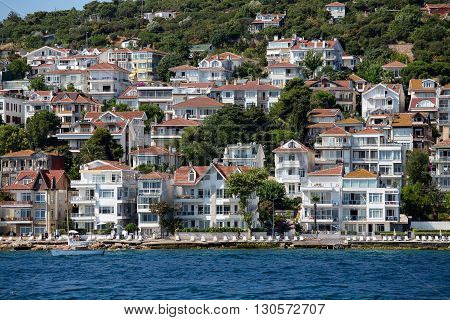 PRINCES ISLANDS TURKEY - JULY 18 2015 : View from the ferry which runs along the route Istanbul - Buyukada. Architecture and tourists on the island Kinaliada