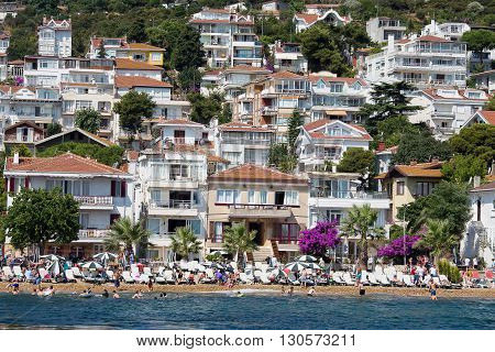 PRINCES ISLANDS TURKEY - JULY 18 2015 : View from the ferry which runs along the route Istanbul - Buyukada. Architecture and tourists on the island Kinaliada