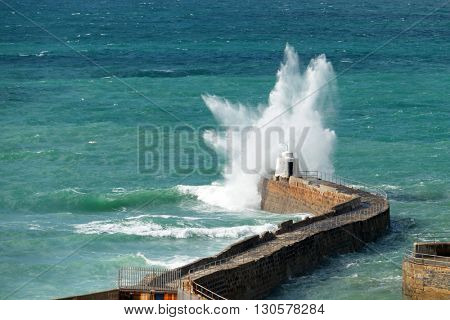 Portreath pier big white water wave splash, Cornwall England.
