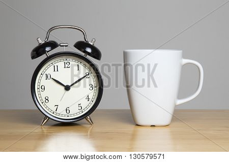 Cup of tea and alarm clock on unit