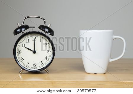 Alarm clock and cup of tea on a desk