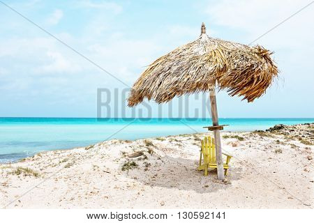 Grass umbrella at the beach on Aruba island  in the Caribbean
