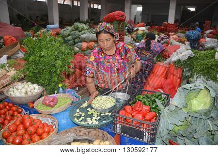 QUETZALTENANGO GUATEMALA april 28 2016 : Woman sale fruits in Quetzaltenango maket. This native market is the most colorful in Central America