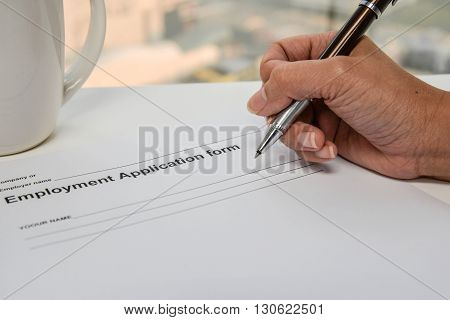 Writing Employment application form and coffee cup