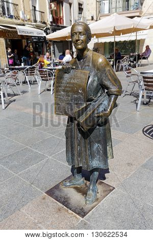 Caceres Spain - March 16 2016: The statue of the popular selling Leoncia Gomez Galan Extremadura the last town crier of Extremadura newspaper.