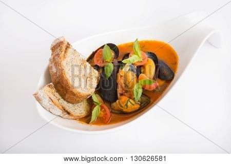 Fresh yellow italian mussels soup with croutons