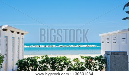 Cabins on the Adriatic beach and sea in the background