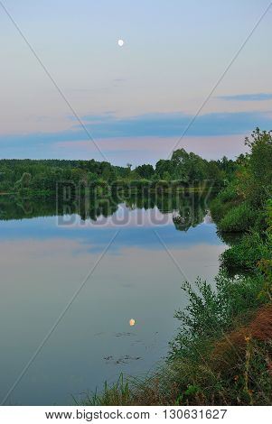 The reflection of the moon in the lake. The village of Voznesenskoye