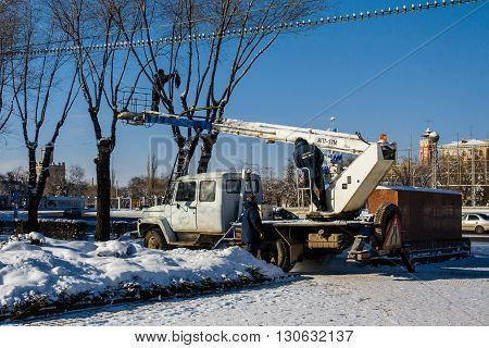 Volgograd, Russia - January 22 2012: Workers decorate the trees on the Ploshhad' Pavshih Borcov (the Square of the Fallen Fighters) in Volgograd