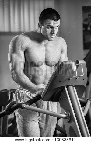 Strong man. Muscle training in the gym. Training in the gym.