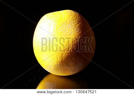 Orange fruit isolated on black background, dark