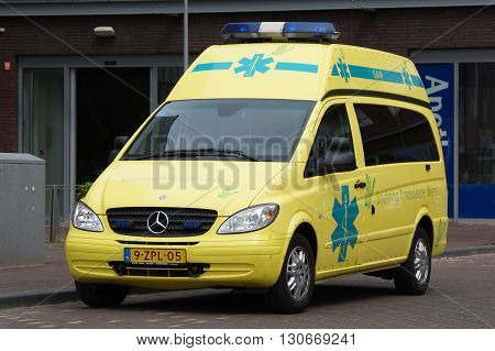 Almere, The Netherlands - May 21, 2016: Yellow Dutch Mercedes Vito Ambulance  parked bij the side of the road. Nobody in the vehicle.