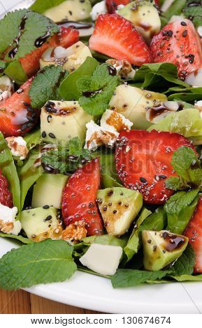 Salad spinach with strawberries avocado mint ricotta and sesamepoppy seeds