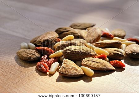 almonds and pine nuts Isolated on a wooden background