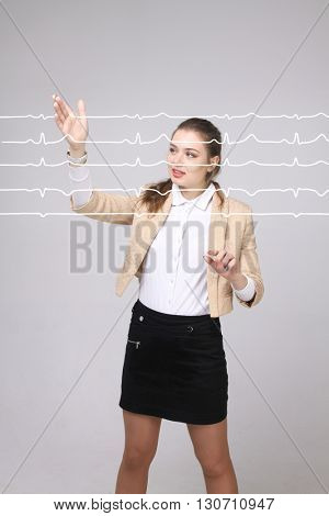 Doctor woman working with cardiogram lines