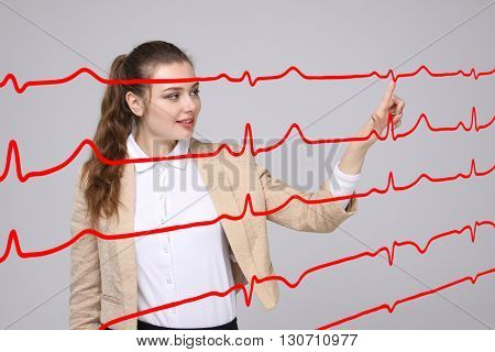 Doctor woman working with cardiogram lines