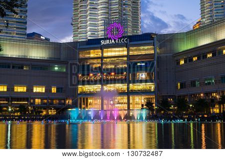 KUALA LUMPUR MALAYSIA - FEBRUARY 29: Colorful fountain show with music in front of Suria KLCC Mall on February 29 2016 in Kuala Lumpur Malaysia. Suria KLCC is one of the premier shopping mall in Malaysia.