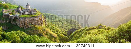 Ancient monastery in setting sun. Tatev. Armenia