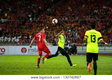July 24, 2015- Shah Alam, Malaysia: Liverpool's James Milner (red) heads the ball in a friendly match against the Malaysian Team. Liverpool Football Club from England is on an Asia tour.