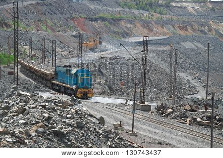 Cargo train carrying iron ore from the opencast mining