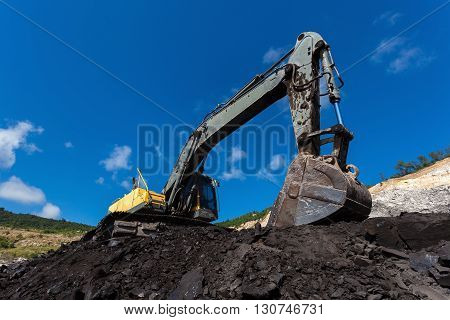 Yellow Backhoe Work In Coalmine