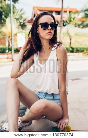 Hipster Girl With Skateboard On The Street.