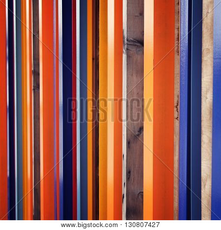 Colorful fence. Repeated wooden blocks. Aged photo. Abstract geometric background. Vintage filter photo. Urban design.