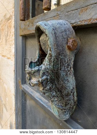Antique door knocker in the form of a boot on old metal door. Photo taken in Jaffa Israel.