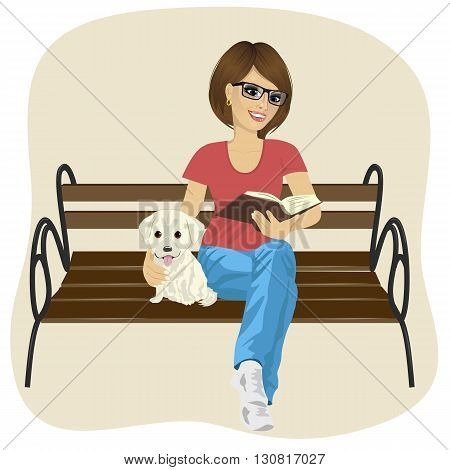 Young happy woman enjoying freetime outside reading a book sitting on a bench hugging labrador puppy