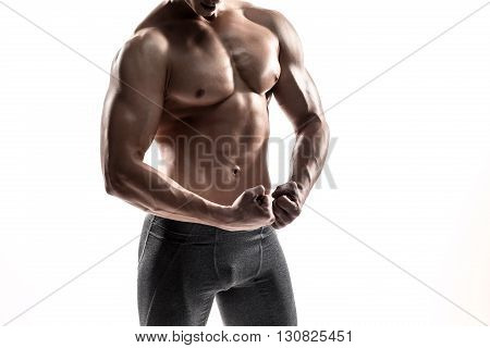 Close-up strong bodybuilder man posing with perfect abs, houlders, biceps, triceps and chest. Isolated on white background