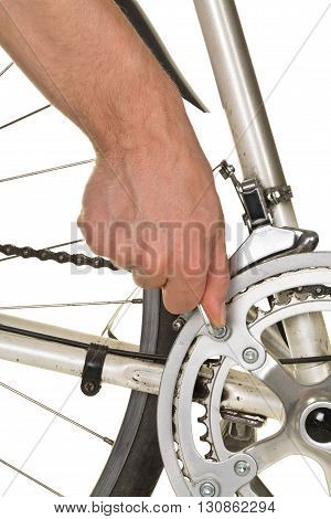 Man fixing chainring on a bicycle on white background - bike repair concept