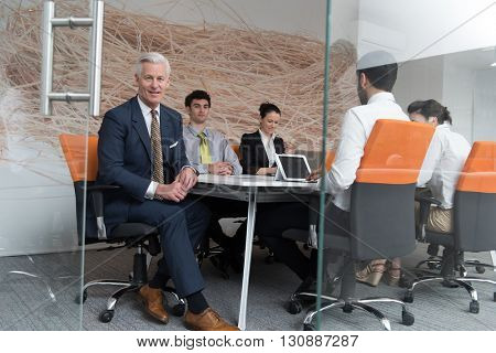 business people group brainstorming on meeting and businessman presenting ideas and projects oon laptop and tablet computer